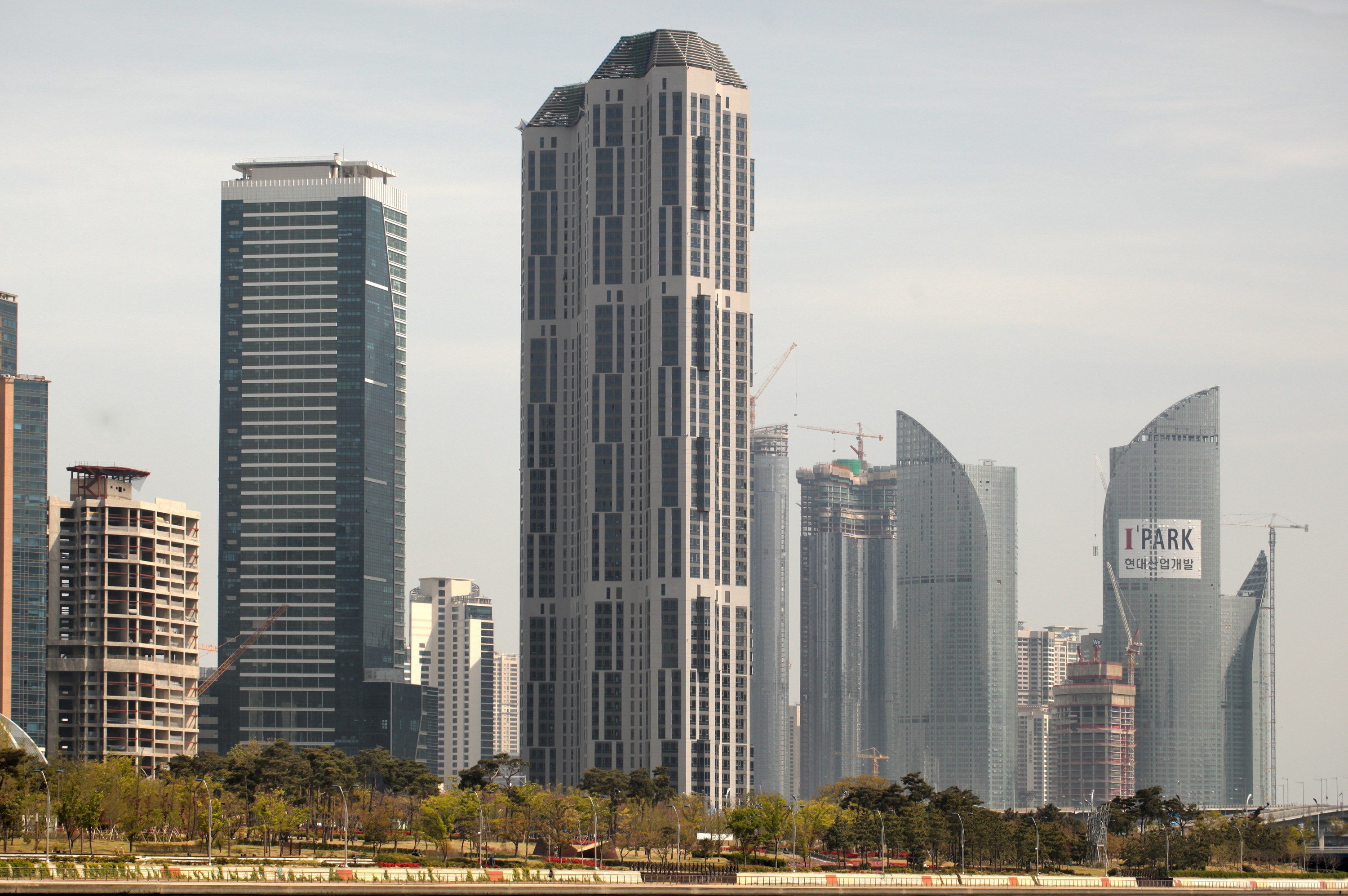 Highrise City. Greenery skyscrapers background.